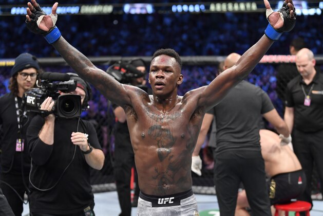 MELBOURNE, AUSTRALIA - OCTOBER 06:  Israel Adesanya of Nigeria celebrates after his knockout victory over Robert Whittaker of New Zealand in their UFC middleweight championship fight during the UFC 243 event at Marvel Stadium on October 06, 2019 in Melbourne, Australia. (Photo by Jeff Bottari/Zuffa LLC/Zuffa LLC via Getty Images)