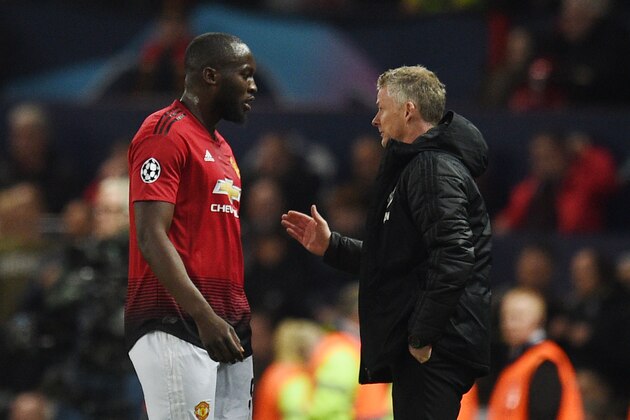 Manchester United's Belgian forward Romelu Lukaku (L) speaks with Manchester United's Norwegian manager Ole Gunnar Solskjaer during the UEFA Champions league first leg quarter-final football match between Manchester United and Barcelona at Old Trafford in Manchester, north west England, on April 10, 2019. (Photo by Oli SCARFF / AFP)        (Photo credit should read OLI SCARFF/AFP/Getty Images)