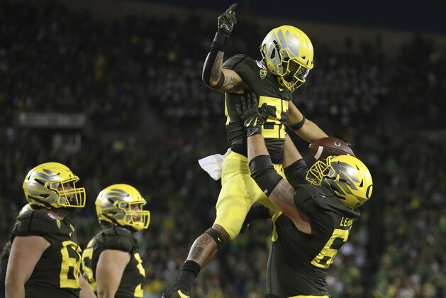 Oregon's Cyrus Habibi-Likio is hoisted in celebration by Shane Lemieux after scoring a touchdown against California during the third quarter of an NCAA college football game Saturday, Oct. 5, 2019, in Eugene, Ore. (AP Photo/Chris Pietsch)