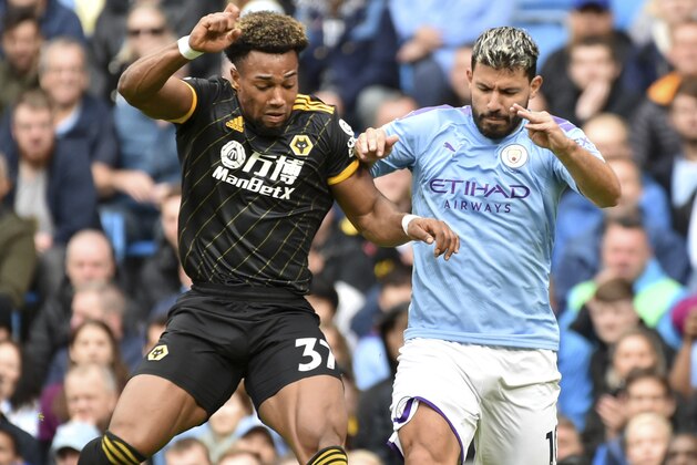 Manchester City's Sergio Aguero, right, and Wolverhampton Wanderers' Adama Traore battle for the ball during the English Premier League soccer match between Manchester City and Wolverhampton Wanderers at Etihad stadium in Manchester, England, Sunday, Oct. 6, 2019. (AP Photo/Rui Vieira)