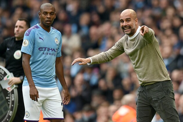 Manchester City's Spanish manager Pep Guardiola (R) gives instructions to Manchester City's Brazilian midfielder Fernandinho during the English Premier League football match between Manchester City and Wolverhampton Wanderers at the Etihad Stadium in Manchester, north west England, on October 6, 2019. (Photo by Oli SCARFF / AFP) / RESTRICTED TO EDITORIAL USE. No use with unauthorized audio, video, data, fixture lists, club/league logos or 'live' services. Online in-match use limited to 120 images. An additional 40 images may be used in extra time. No video emulation. Social media in-match use limited to 120 images. An additional 40 images may be used in extra time. No use in betting publications, games or single club/league/player publications. /  (Photo by OLI SCARFF/AFP via Getty Images)
