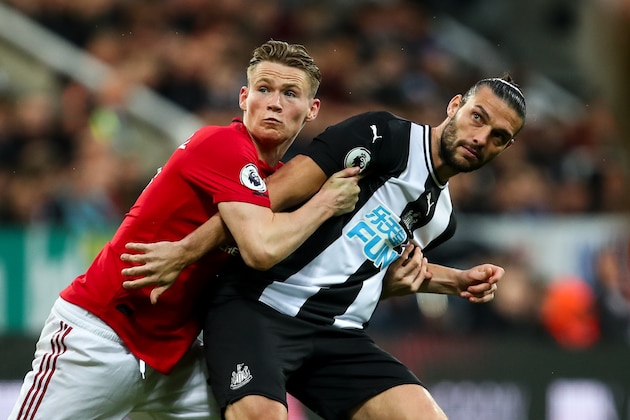 NEWCASTLE UPON TYNE, ENGLAND - OCTOBER 06: Scott McTominay of Manchester United and Andy Carroll of Newcastle United during the Premier League match between Newcastle United and Manchester United at St. James Park on October 6, 2019 in Newcastle upon Tyne, United Kingdom. (Photo by Robbie Jay Barratt - AMA/Getty Images)