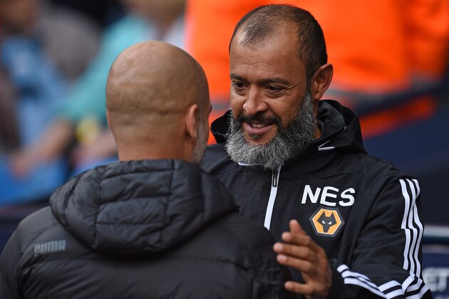 Manchester City's Spanish manager Pep Guardiola (L) greets Wolverhampton Wanderers' Portuguese head coach Nuno Espirito Santo during the English Premier League football match between Manchester City and Wolverhampton Wanderers at the Etihad Stadium in Manchester, north west England, on October 6, 2019. (Photo by Oli SCARFF / AFP) / RESTRICTED TO EDITORIAL USE. No use with unauthorized audio, video, data, fixture lists, club/league logos or 'live' services. Online in-match use limited to 120 images. An additional 40 images may be used in extra time. No video emulation. Social media in-match use limited to 120 images. An additional 40 images may be used in extra time. No use in betting publications, games or single club/league/player publications. /  (Photo by OLI SCARFF/AFP via Getty Images)