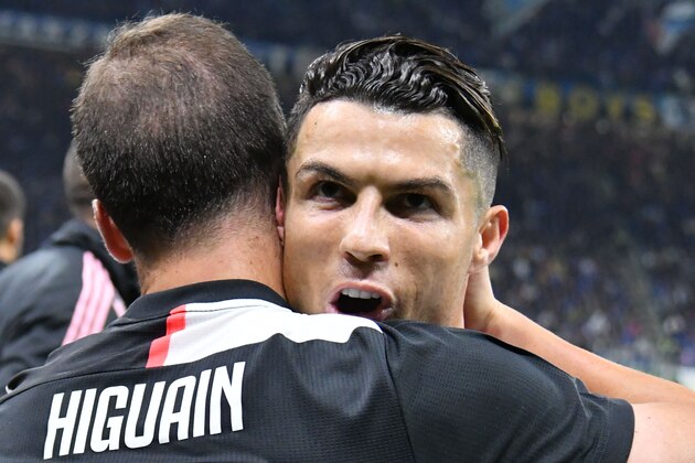 Juventus' Argentinian forward Gonzalo Higuain (L) celebrates with Juventus' Portuguese forward Cristiano Ronaldo after scoring during the Italian Serie A football match Inter vs Juventus on October 6, 2019 at the San Siro stadium in Milan. (Photo by Alberto PIZZOLI / AFP) (Photo by ALBERTO PIZZOLI/AFP via Getty Images)