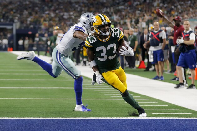 Green Bay Packers' Aaron Jones (33) reaches the end zone for a touchdown in front of Dallas Cowboys' Byron Jones during the second half of an NFL football game in Arlington, Texas, Sunday, Oct. 6, 2019. (AP Photo/Michael Ainsworth)