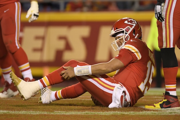 Kansas City Chiefs quarterback Patrick Mahomes holds his leg after he is tackled by Indianapolis Colts defensive ends Kemoko Turay and Justin Houston during the second half of an NFL football game in Kansas City, Mo., Sunday, Oct. 6, 2019. (AP Photo/Reed Hoffmann)