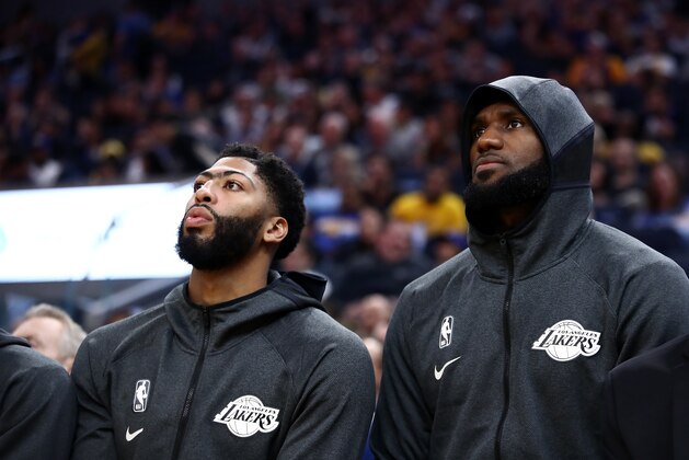 SAN FRANCISCO, CALIFORNIA - OCTOBER 05:  Anthony Davis (left) #3 sits next to LeBron James #23 of the Los Angeles Lakers during their game against the Golden State Warriors  at Chase Center on October 05, 2019 in San Francisco, California.  NOTE TO USER: User expressly acknowledges and agrees that, by downloading and or using this photograph, User is consenting to the terms and conditions of the Getty Images License Agreement.  (Photo by Ezra Shaw/Getty Images)