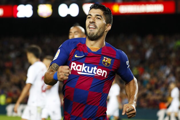 Barcelona's Luis Suarez celebrates after scoring the opening goal during Spanish La Liga soccer match between Barcelona and Sevilla at the Camp Nou stadium in Barcelona, Sunday, Oct. 6, 2019. (AP Photo/Joan Monfort)