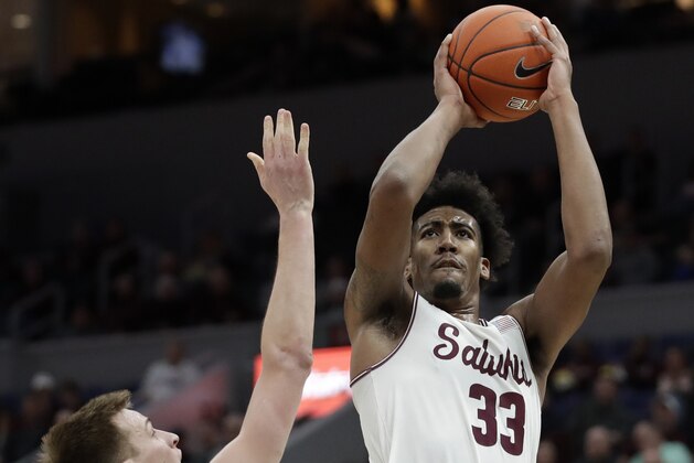 Southern Illinois' Kavion Pippen (33) shoots over Northern Iowa's Luke McDonnell (34) during the first half of an NCAA college basketball game in the quarterfinal round of the Missouri Valley Conference tournament, Friday, March 8, 2019, in St. Louis. (AP Photo/Jeff Roberson)
