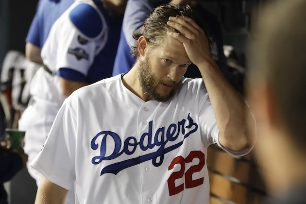 Los Angeles Dodgers starting pitcher Clayton Kershaw walks in the dugout after leaving the during the sixth inning in Game 2 of the baseball team's National League Division Series against the Washington Nationals on Friday, Oct. 4, 2019, in Los Angeles. (AP Photo/Marcio Jose Sanchez)