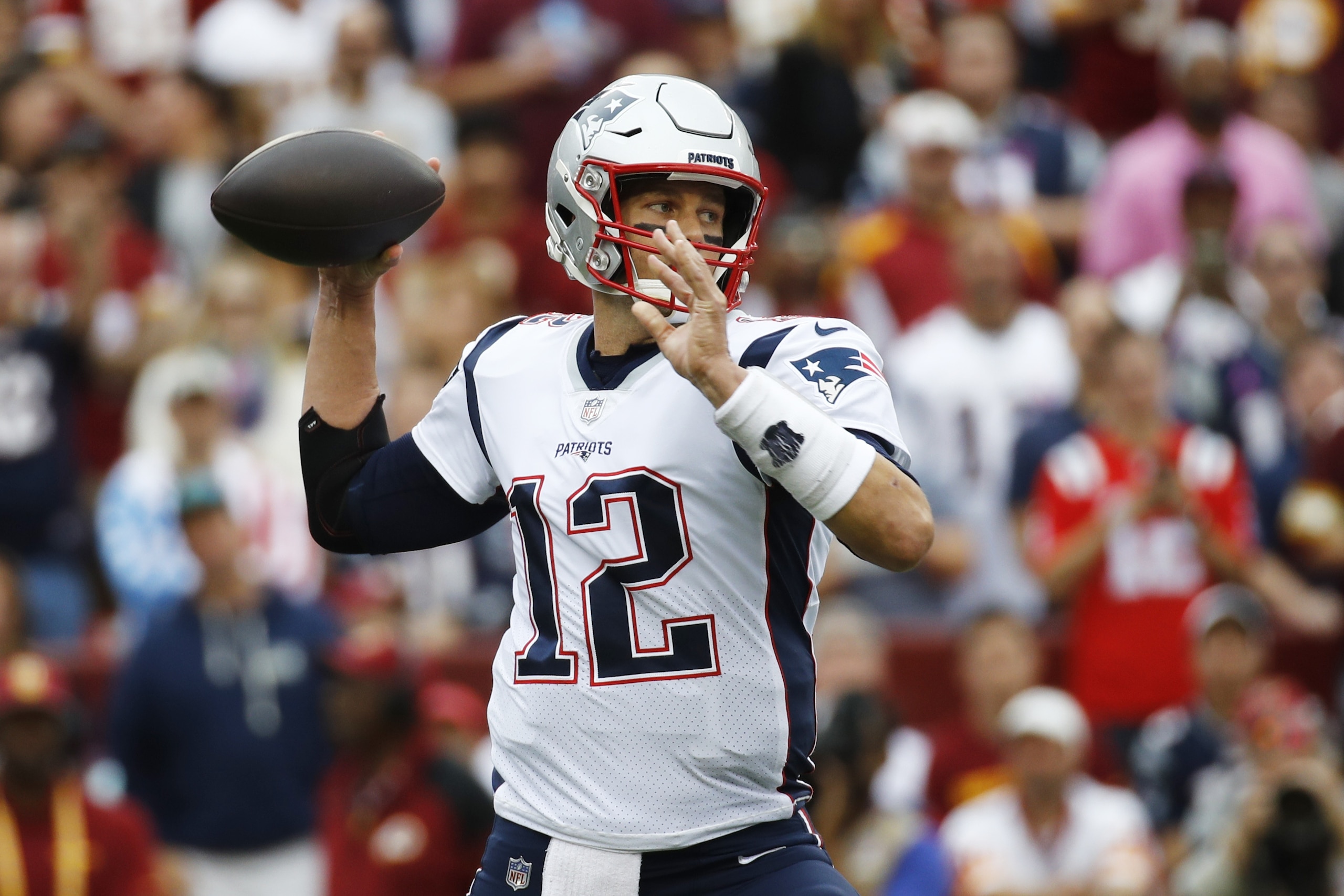 New England Patriots quarterback Tom Brady (12) works in ther pocket against the Washington Redskins during the first half of an NFL football game, Sunday, Oct. 6, 2019, in Landover, Md. (AP Photo/Patrick Semansky)