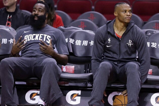 HOUSTON, TEXAS - SEPTEMBER 30: James Harden #13 of the Houston Rockets, left, and Russell Westbrook #0 sit in the bench during warmups  before playing a pre-season game against the Shanghai Sharks at Toyota Center on September 30, 2019 in Houston, Texas. NOTE TO USER: User expressly acknowledges and agrees that, by downloading and/or using this photograph, user is consenting to the terms and conditions of the Getty Images License Agreement.  (Photo by Bob Levey/Getty Images)