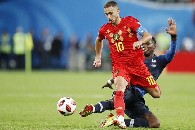 Belgium's Eden Hazard, left, is tackled by France's Paul Pogba during the semifinal match between France and Belgium at the 2018 soccer World Cup in the St. Petersburg Stadium, in St. Petersburg, Russia, Tuesday, July 10, 2018. (AP Photo/David Vincent)