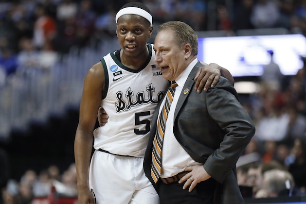 FILE - In this March 29, 2019, file photo, Michigan State guard Cassius Winston (5) puts his arm around coach Tom Izzo following the team's 80-63 win over LSU in an NCAA men's college basketball tournament East Region semifinal, in Washington. Winston has joined a select group of players in program history as an All-America player and Big Ten player of the year. If he can help the Spartans win two more games, he'll join Magic Johnson and Mateen Cleaves as the school's national championship-winning point guards. (AP Photo/Patrick Semansky, File)