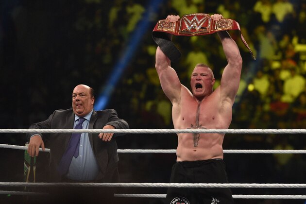Brock Lesnar celebrates, with his manager Paul Heyman, after winning the WWE Universal Championship match as part of as part of the World Wrestling Entertainment (WWE) Crown Jewel pay-per-view at the King Saud University Stadium in Riyadh on November 2, 2018. (Photo by Fayez Nureldine / AFP)        (Photo credit should read FAYEZ NURELDINE/AFP/Getty Images)