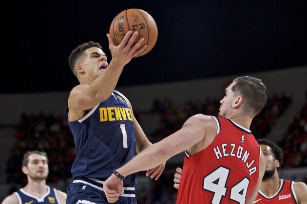 Denver Nuggets forward Michael Porter Jr., left, shoots over Portland Trail Blazers forward Mario Hezonja during the second half of a preseason NBA basketball game in Portland, Ore., Tuesday, Oct. 8, 2019. (AP Photo/Craig Mitchelldyer)