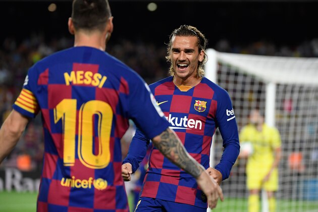 Barcelona's French forward Antoine Griezmann (R) is congratulated by teammate Barcelona's Argentine forward Lionel Messi after scoring the first goal during the Spanish league football match between FC Barcelona and Villarreal CF at the Camp Nou stadium in Barcelona, on September 24, 2019. (Photo by LLUIS GENE / AFP)        (Photo credit should read LLUIS GENE/AFP/Getty Images)