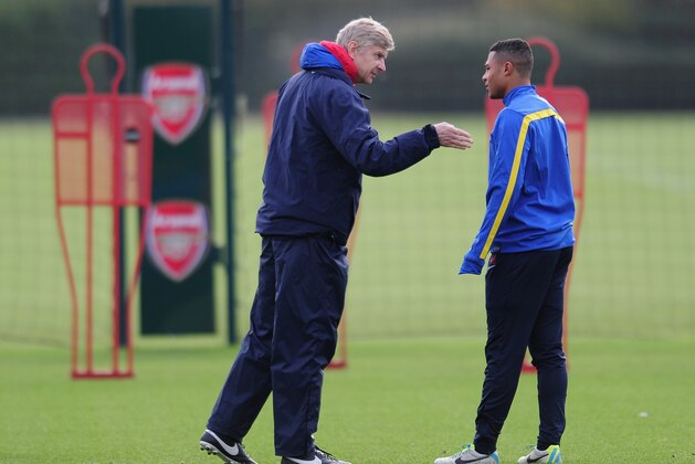 ST ALBANS, ENGLAND - NOVEMBER 25:  Arsenal manager Arsene Wenger talks with player Serge Gnabry during a training session at London Colney on November 25, 2013 in St Albans, England.  (Photo by Shaun Botterill/Getty Images)