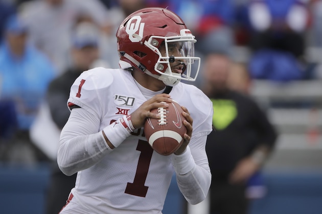 Oklahoma quarterback Jalen Hurts looks for a receiver during the second half of an NCAA college football game against Kansas, Saturday, Oct. 5, 2019, in Lawrence, Kan. (AP Photo/Charlie Riedel)