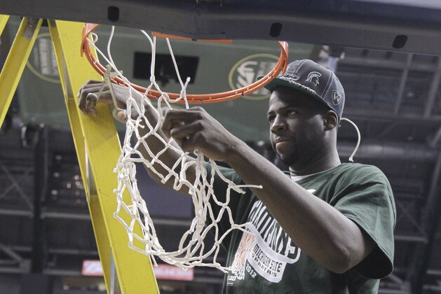 Michigan State forward Draymond Green cuts the net after his team's 68-64 win over Ohio State in an NCAA college basketball game in the final of the Big Ten men's tournament in Indianapolis, Sunday, March 11, 2012. (AP Photo/Michael Conroy)