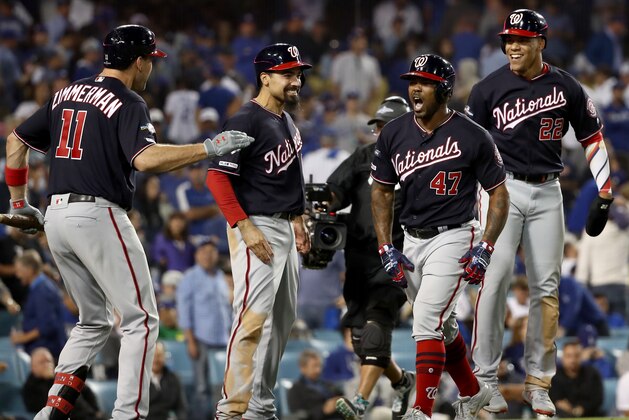 LOS ANGELES, CALIFORNIA - OCTOBER 09: Howie Kendrick #47 of the Washington Nationals celebrates after hitting a grand slam with teammates Juan Soto #22, Ryan Zimmerman #11 and Anthony Rendon #6 in the tenth inning of game five of the National League Division Series against the Los Angeles Dodgers at Dodger Stadium on October 09, 2019 in Los Angeles, California. (Photo by Sean M. Haffey/Getty Images)
