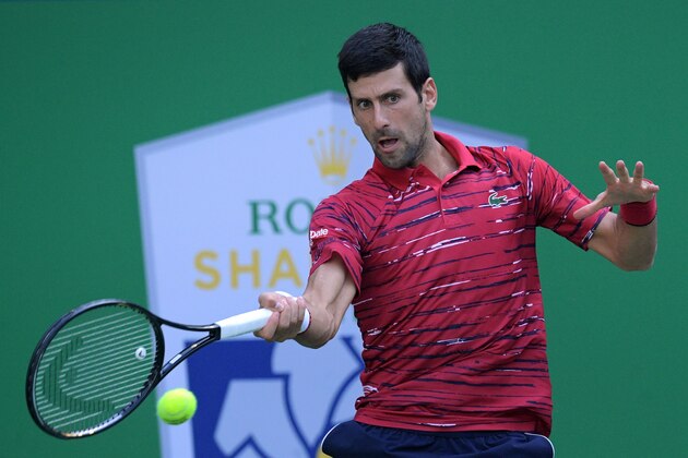 Novak Djokovic of Serbia hits a return during his men's singles third round match against John Isner of the US at the Shanghai Masters tennis tournament in Shanghai on October 10, 2019. (Photo by NOEL CELIS / AFP) (Photo by NOEL CELIS/AFP via Getty Images)