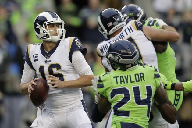 Los Angeles Rams quarterback Jared Goff, left, passes against the Seattle Seahawks during the first half of an NFL football game, Thursday, Oct. 3, 2019, in Seattle. (AP Photo/Stephen Brashear)