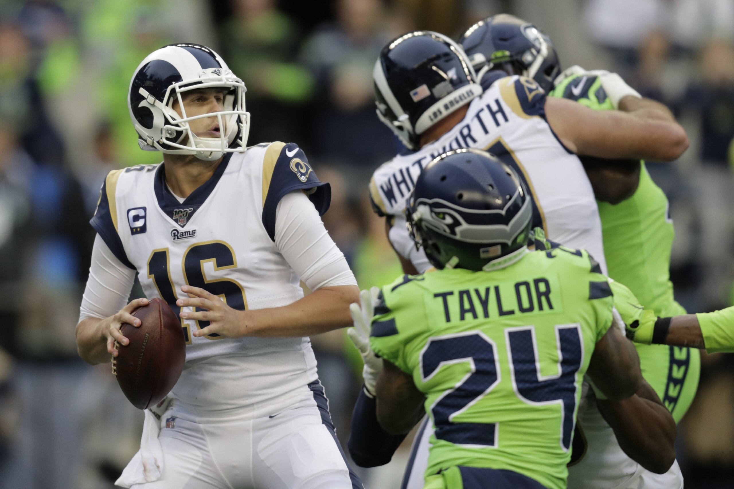 Los Angeles Rams quarterback Jared Goff, left, passes against the Seattle Seahawks during the first half of an NFL football game, Thursday, Oct. 3, 2019, in Seattle. (AP Photo/Stephen Brashear)