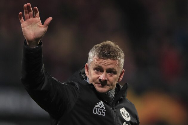 Manchester United's manager Ole Gunnar Solskjaer waves goodbye to fans after the group L Europa League soccer match between AZ Alkmaar and Manchester United at the ADO Den Haag stadium in The Hague, Netherlands, Thursday, Oct. 3, 2019. (AP Photo/Peter Dejong)