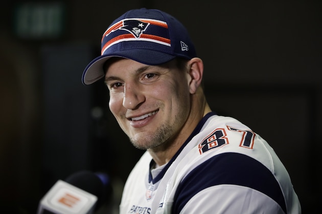 FILE - In this Jan. 30, 2019 file photo New England Patriots' Rob Gronkowski speaks with members of the media during a news conference ahead of the NFL Super Bowl 53 football game against Los Angeles Rams in Atlanta. As teams settle in at sweltering training camps this week, playbooks are distributed (digitally, of course), rookies and other youngsters try to catch the eye of decision makers, and fans wonder what their teams will look like in early September. And beyond. Except, perhaps, in New England. We’re not likely to see much of Patriots quarterback Tom Brady until opening day. We won’t see any of his buddy and standout tight end, Rob Gronkowski, whose battered body caused him to retire. (AP Photo/Matt Rourke, file)
