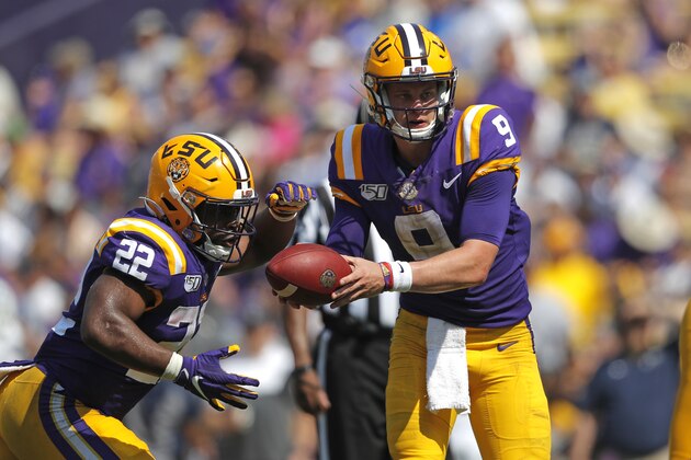 LSU quarterback Joe Burrow (9) hands off to running back Clyde Edwards-Helaire (22) in the first half of an NCAA college football game against Utah State in Baton Rouge, La., Saturday, Oct. 5, 2019. LSU won 42-6. (AP Photo/Gerald Herbert)