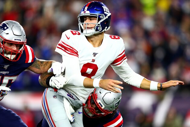 FOXBOROUGH, MASSACHUSETTS - OCTOBER 10: Daniel Jones #8 of the New York Giants gets tackled by the New England Patriots during the second quarter in the game at Gillette Stadium on October 10, 2019 in Foxborough, Massachusetts. (Photo by Adam Glanzman/Getty Images)