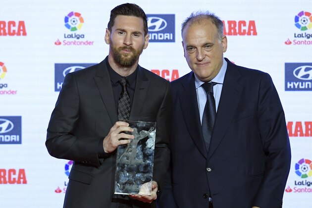 Barcelona's Argentinian forward Lionel Messi (L) poses with the president of La Liga, Javier Tebas, after receiving the Alfredo Di Stefano trophy for the 2017-18 best player of the Spanish Liga, during the presentation of the Football Marca Awards in Barcelona on November 12, 2018. (Photo by LLUIS GENE / AFP)        (Photo credit should read LLUIS GENE/AFP/Getty Images)
