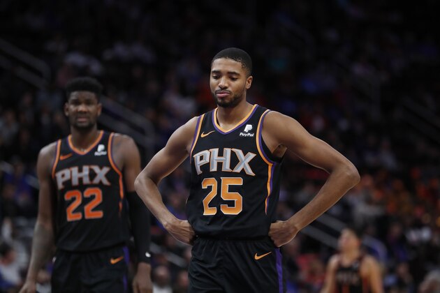 Phoenix Suns center Deandre Ayton (22) and forward Mikal Bridges (25) stand on the court during the second half of an NBA basketball game against the Detroit Pistons, Sunday, Nov. 25, 2018, in Detroit. (AP Photo/Carlos Osorio)