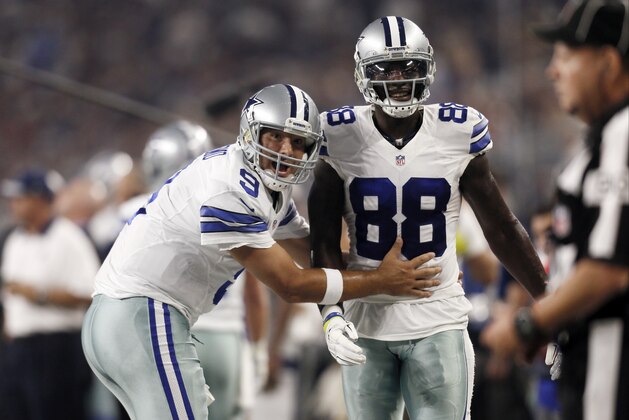FILE - In this Sept. 13, 2015, file photo, Dallas Cowboys quarterback Tony Romo (9) and wide receiver Dez Bryant (88) react during the first half of an NFL football game against the New York Giants in Arlington, Texas. Both are anxious to get on the field together after injuries kept them apart most of last season, when Dallas slid from first to worst in the NFC East. (AP Photo/Brandon Wade, File)