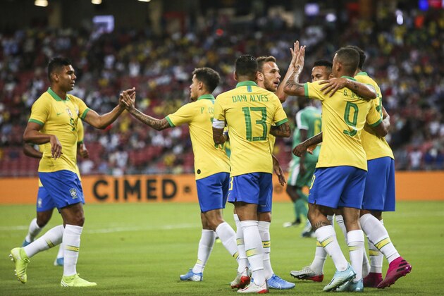 Brazil players celebrate after a goal during the Brazil Global Tour 2019 international friendly soccer match between Brazil and Senegal in Singapore, Thursday, Oct. 10, 2019. (AP Photo/Danial Hakim)