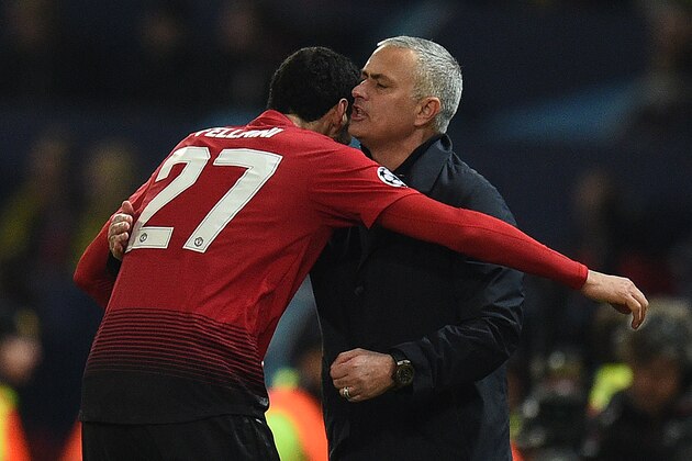Manchester United's Belgian midfielder Marouane Fellaini (L) celebrates scoring his team's first goal with Manchester United's Portuguese manager Jose Mourinho during the UEFA Champions League group H football match between Manchester United and Young Boys at Old Trafford in Manchester, north-west England on November 27, 2018. (Photo by Oli SCARFF / AFP)        (Photo credit should read OLI SCARFF/AFP/Getty Images)