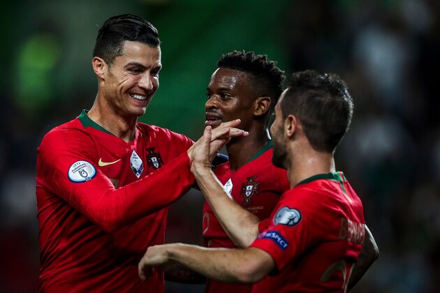 Portugal's forward Bernardo Silva (R) celebrates with Portugal's forward Cristiano Ronaldo (L) and Portugal's defender Nelson Semedo (C) after scoring a goal during the Euro 2020 qualifier football match between Portugal and Luxembourg at the Jose Alvalade stadium in Lisbon on October 11, 2019. (Photo by CARLOS COSTA / AFP) (Photo by CARLOS COSTA/AFP via Getty Images)