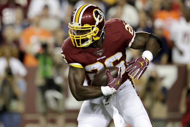 Washington Redskins running back Adrian Peterson runs with the ball against the Chicago Bears during the first half of an NFL football game Monday, Sept. 23, 2019, in Landover, Md. (AP Photo/Julio Cortez)