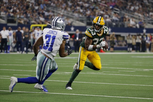 Dallas Cowboys cornerback Byron Jones (31) defends as Green Bay Packers running back Aaron Jones (33) runs the ball into the end zone for at touchdown during an NFL football game in Arlington, Texas, Sunday, Oct. 6, 2019. (AP Photo/Michael Ainsworth)