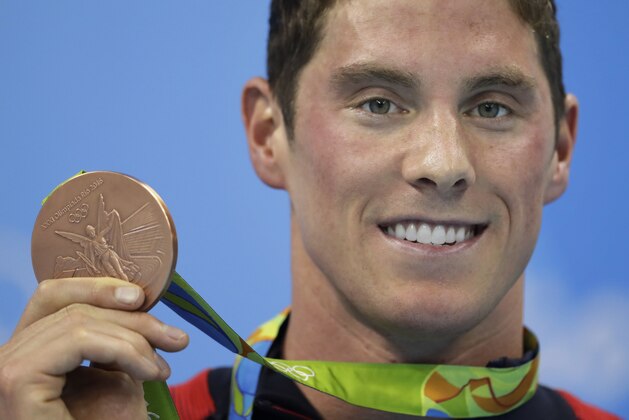 United States' Conor Dwyer shows off his bronze medal during the medal ceremony for the men's 200-meter freestyle final during the swimming competitions at the 2016 Summer Olympics, Monday, Aug. 8, 2016, in Rio de Janeiro, Brazil. (AP Photo/Michael Sohn)