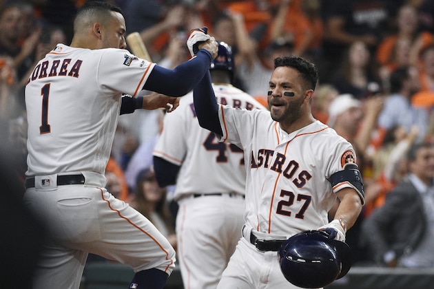 Houston Astros second baseman Jose Altuve (27) celebrates his solo home run against the Tampa Bay Rays with Carlos Correa (1) during the eighth inning of Game 5 of a baseball American League Division Series in Houston, Thursday, Oct. 10, 2019. (AP Photo/Eric Christian Smith)
