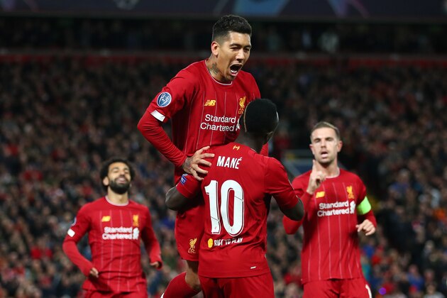 LIVERPOOL, ENGLAND - OCTOBER 02: Sadio Mane of Liverpool celebrates with Roberto Firmino after scoring his sides first goal during the UEFA Champions League group E match between Liverpool FC and RB Salzburg at Anfield on October 02, 2019 in Liverpool, United Kingdom. (Photo by Clive Brunskill/Getty Images)