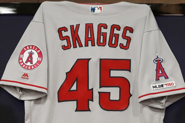 The jersey of the late Tyler Skaggs hangs on the wall during a news conference with team management and ownership before a baseball game against the Texas Rangers in Arlington, Texas, Tuesday, July 2, 2019. Skaggs passed away on Monday in Southlake, Texas. (AP Photo/Tony Gutierrez)