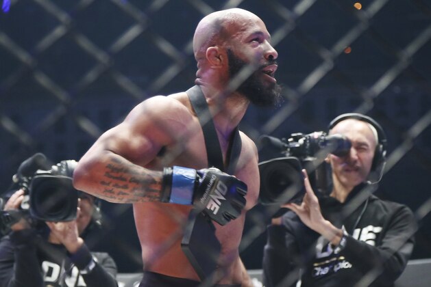 Mixed martial arts (MMA) fighters Demetrious Johnson of the United States celebrates after defeating Japan's Yuya Wakamatsu during their flyweight world grand prix quarterfinal of One Championship bout in Tokyo, Sunday, March 31, 2019. (AP Photo/Koji Sasahara)