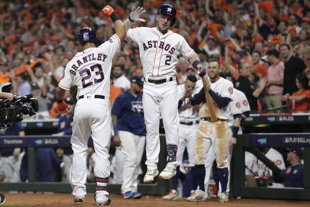 Houston Astros left fielder Michael Brantley (23) celebrates his solo homer against the Tampa Bay Rays with teammate Alex Bregman (2) during the eighth inning of Game 5 of a baseball American League Division Series in Houston, Thursday, Oct. 10, 2019. (AP Photo/Michael Wyke)