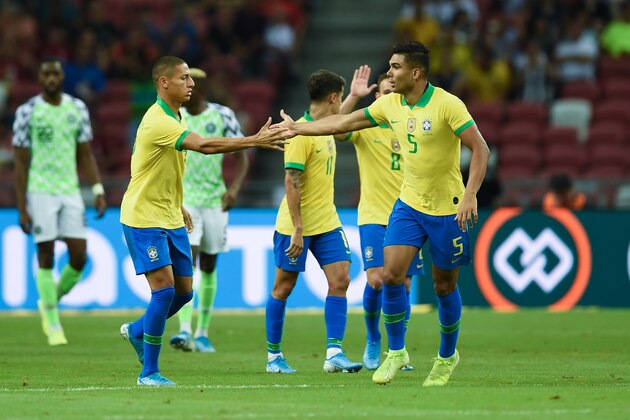 Brazil's midfielder Casemiro (R) celebrates after scoring an equaliser during an international friendly football match between Brazil and Nigeria at the National Stadium in Singapore on October 12, 2019. (Photo by Roslan RAHMAN / AFP) (Photo by ROSLAN RAHMAN/AFP via Getty Images)