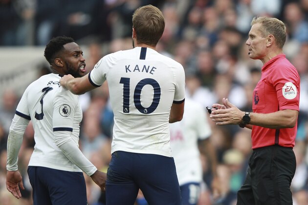 Referee Graham Scott has a word with Tottenham's Danny Rose, left, as teammate Harry Kane, center, tries to calm him down during the English Premier League soccer match between Tottenham Hotspur and Southampton at the White Heart Lane stadium in London, Saturday, Sept. 28, 2019. (AP Photo/Ian Walton)