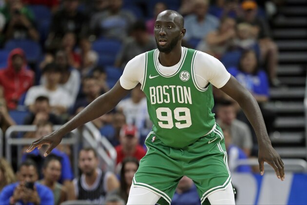 Boston Celtics center Tacko Fall sets on defense during the second half of an NBA preseason basketball game against the Orlando Magic, Friday, Oct. 11, 2019, in Orlando, Fla. (AP Photo/John Raoux)