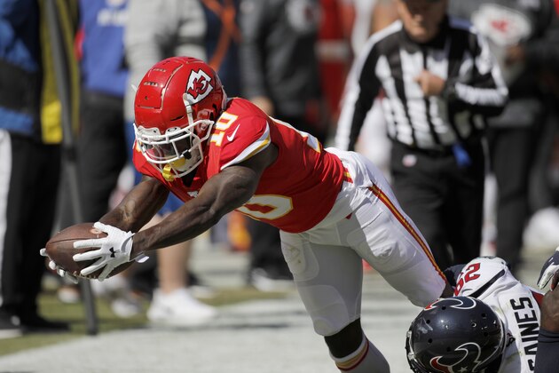 Kansas City Chiefs wide receiver Tyreek Hill (10) dives with the ball against Houston Texans cornerback Phillip Gaines (29) during the first half of an NFL football game in Kansas City, Mo., Sunday, Oct. 13, 2019. (AP Photo/Colin E. Braley)